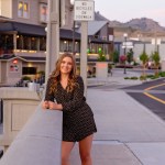 Senior girl leaning on overlook in downtown Chelan